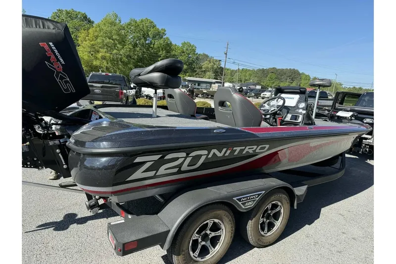 Slide: The Image of 2023 Nitro Z20 Pro bass boat with Mercury Pro XS engine, parked outdoors. - 2