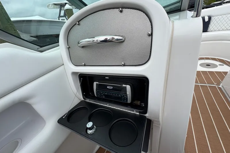Slide: The Image of 2002 Chris-Craft Launch 28 boat interior with stereo system and cup holders. - 13