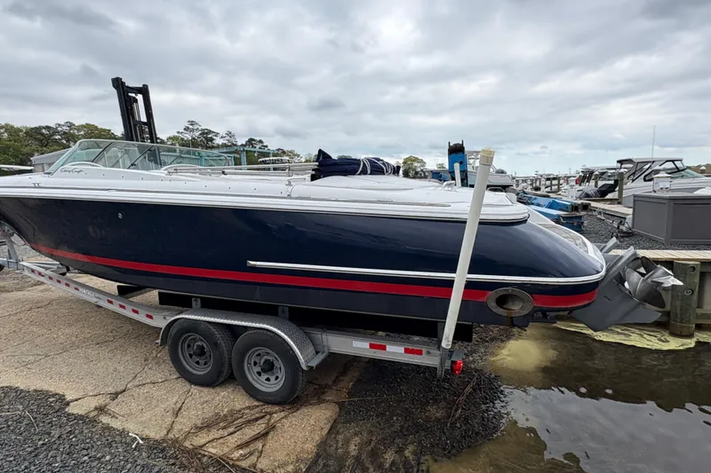 Slide: The Image of 2002 Chris-Craft Launch 28 boat on trailer at marina, overcast sky. - 15