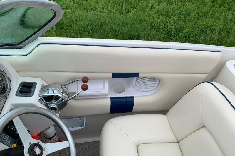 Slide: The Image of Interior of a 2002 Chris Craft 28 Launch boat, featuring steering wheel and controls. - 3