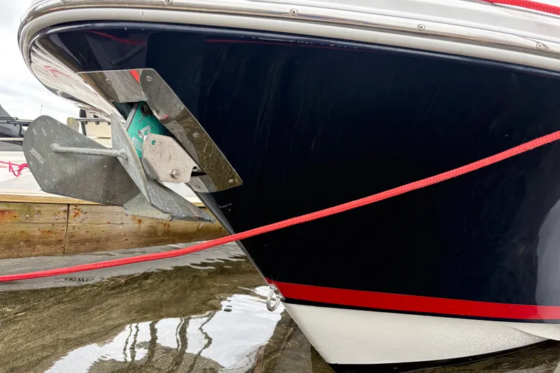 Slide: The Image of Close-up of a 2002 Chris-Craft Launch 28 boat anchor and hull with red trim. - 8