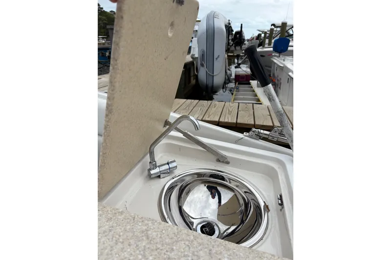 Slide: The Image of 2002 Chris-Craft Launch 28 boat sink with faucet, docked at marina. - 9