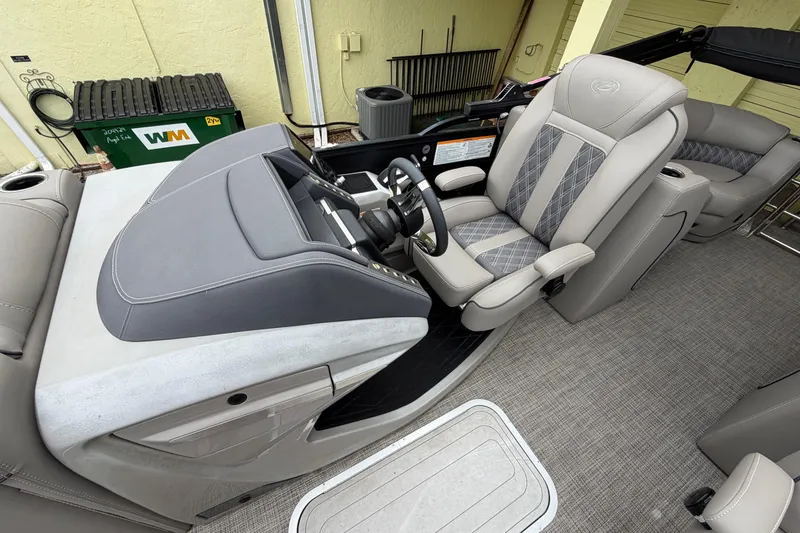 Slide: The Image of Luxurious interior of 2022 Barletta Lusso 23QCSS pontoon boat with elegant seating and helm. - 16