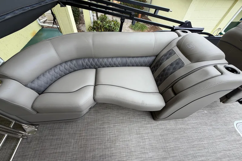 Slide: The Image of 2022 Barletta Lusso 23QCSS boat interior with luxurious gray seating and cup holders. - 17