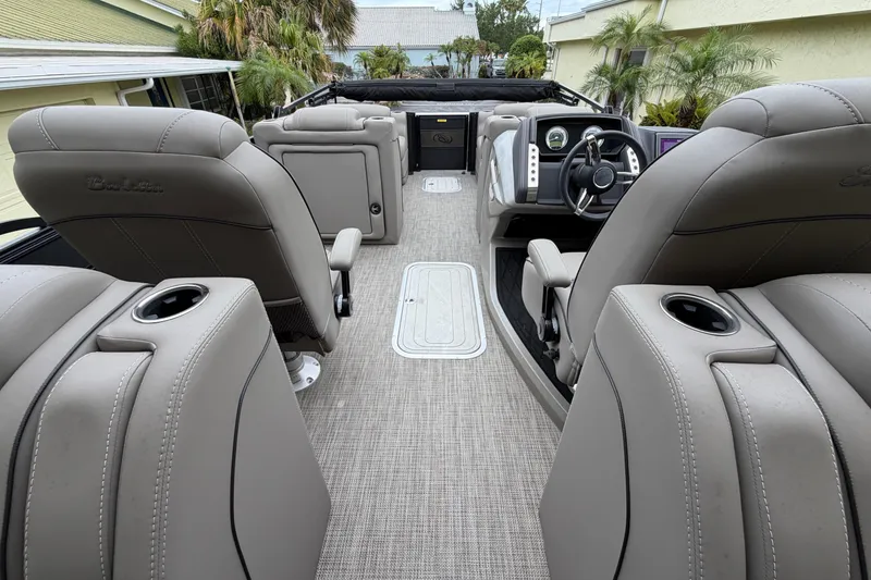 Slide: The Image of 2022 Barletta Lusso 23QCSS interior with luxurious seating and modern dashboard. - 2
