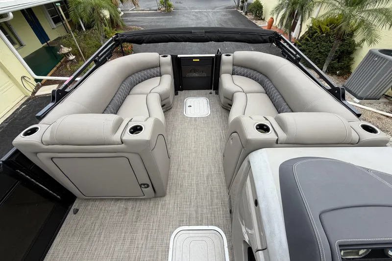 Slide: The Image of 2022 Barletta Lusso 23QCSS pontoon boat interior with luxurious seating and cup holders. - 5