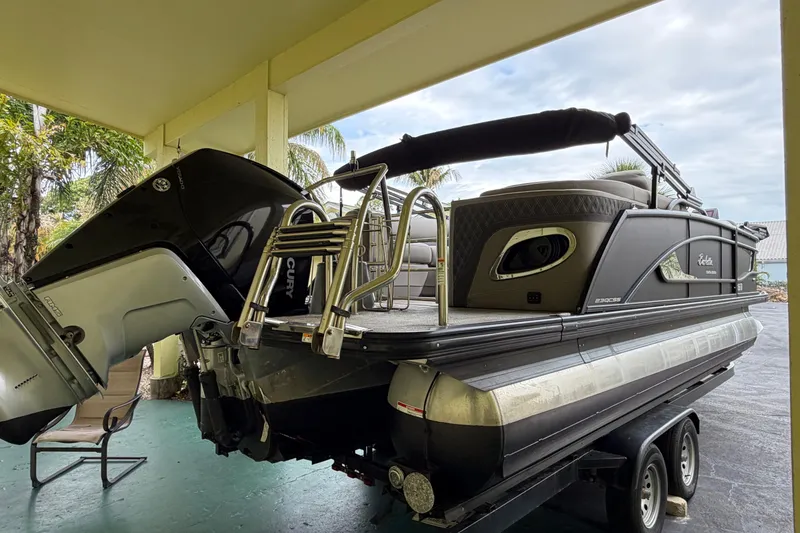 Slide: The Image of 2022 Barletta Lusso 23QCSS pontoon boat with Mercury outboard motor on trailer. - 6