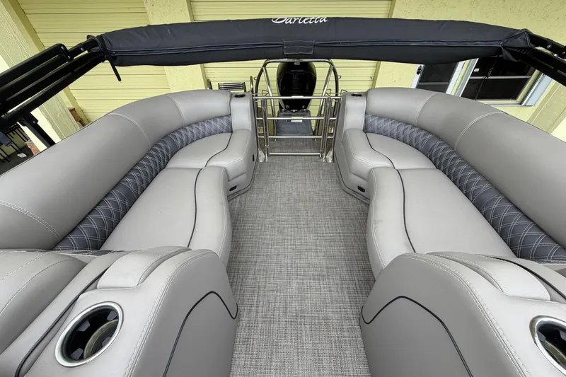 Slide: The Image of 2022 Barletta Lusso 23QCSS pontoon boat interior with luxurious gray seating and cup holders. - 7