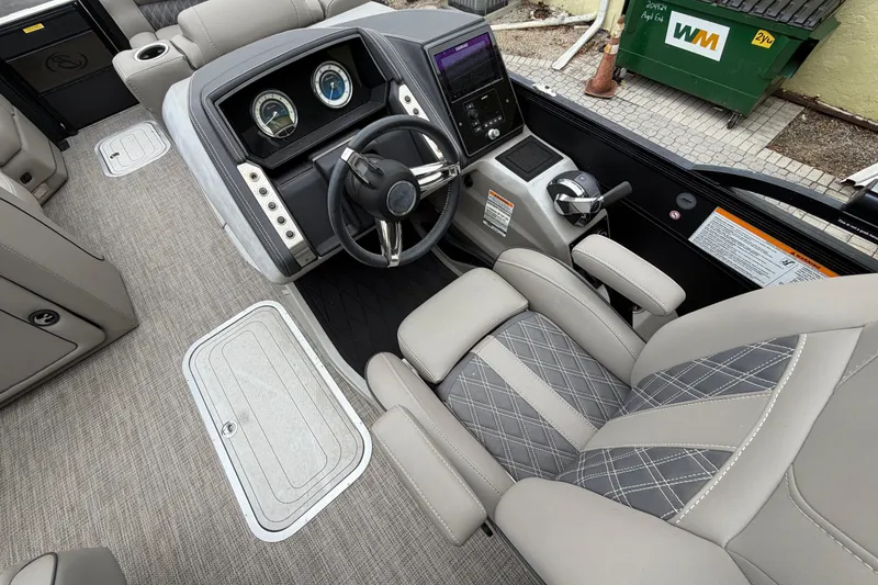 Slide: The Image of Interior of 2022 Barletta Lusso 23QCSS boat, featuring luxurious seating and modern dashboard controls. - 9