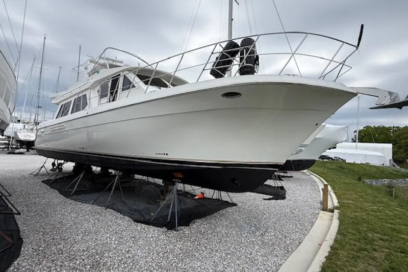 Slide: The Image of 2006 Navigator 53 Extended Deckhouse yacht on dry dock, showcasing sleek design and spacious deck. - 1