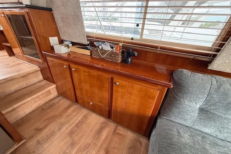 Slide: The Image of Interior of 2006 Navigator 53 Extended Deckhouse with wooden cabinetry and cozy seating. - 10