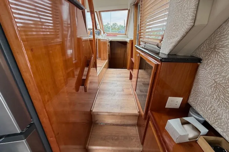 Slide: The Image of Interior of 2006 Navigator 53 Extended Deckhouse with wooden finishes and large windows. - 11
