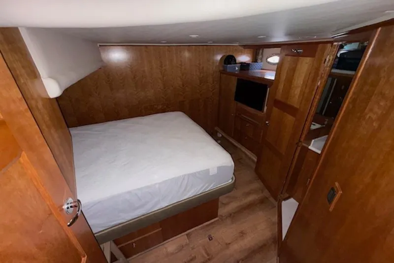 Slide: The Image of Interior cabin of 2006 Navigator 53 Extended Deckhouse with wood paneling and bed. - 12