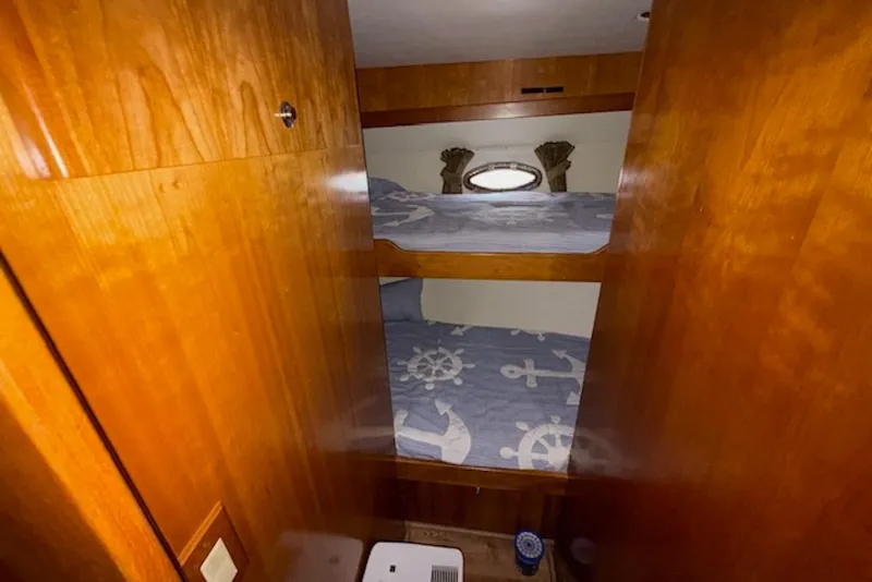 Slide: The Image of Bunk beds in 2006 Navigator 53 Extended Deckhouse with nautical-themed bedding. - 15