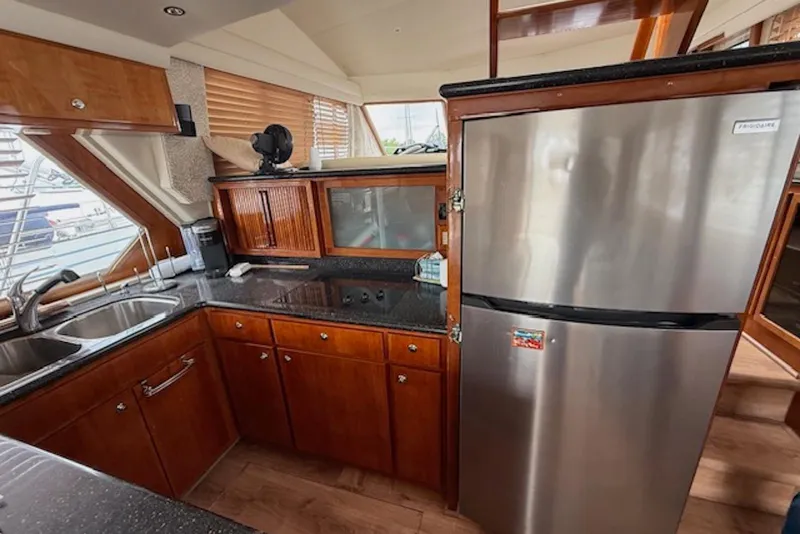 Slide: The Image of Luxurious kitchen interior of 2006 Navigator 53 Extended Deckhouse yacht with stainless steel appliances. - 8