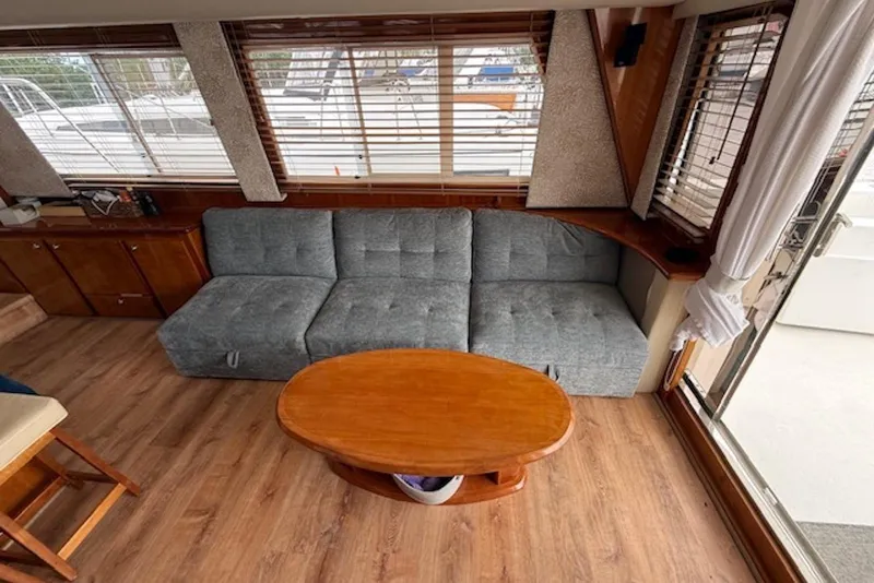 Slide: The Image of Interior of 2006 Navigator 53 Extended Deckhouse with gray sofa and wooden table. - 9