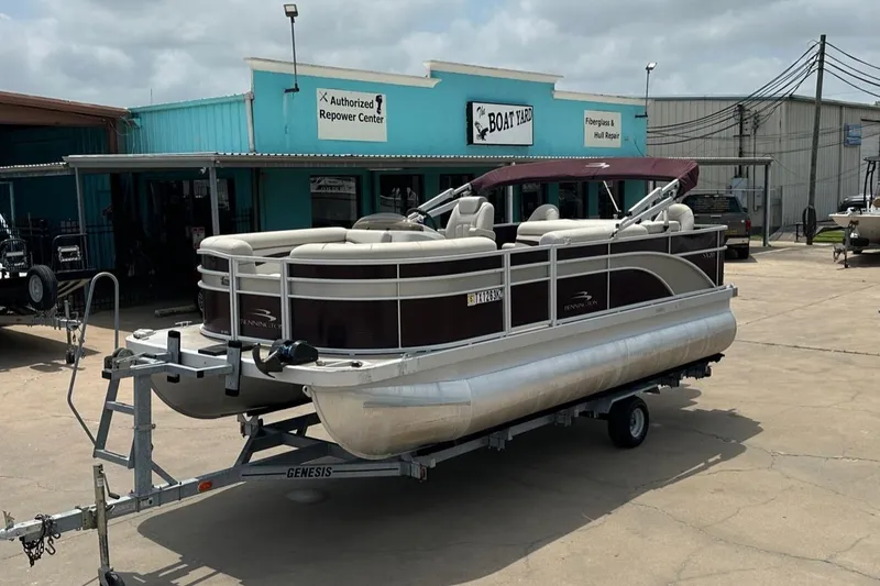 The Image of 2018 Bennington 20 SX Fish pontoon boat on trailer at repair center. - 1
