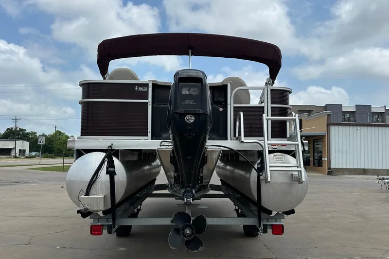 Slide: The Image of 2018 Bennington 20 SX Fish pontoon boat on trailer, rear view, outdoor setting. - 10