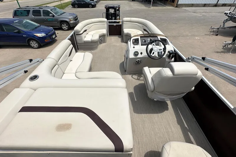 Slide: The Image of 2018 Bennington 20 SX Fish pontoon boat interior with beige seating and steering console. - 11