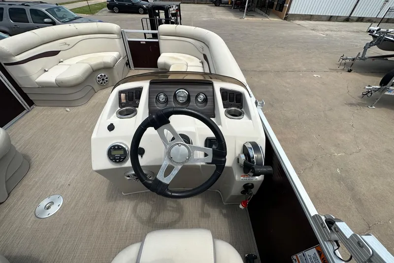 Slide: The Image of 2018 Bennington 20 SX Fish boat interior with steering wheel and seating. - 12