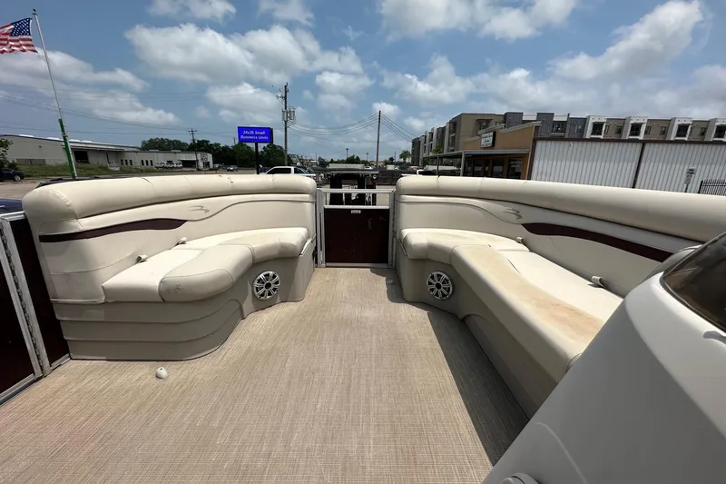 Slide: The Image of 2018 Bennington 20 SX Fish pontoon boat interior with beige seating and speakers. - 15