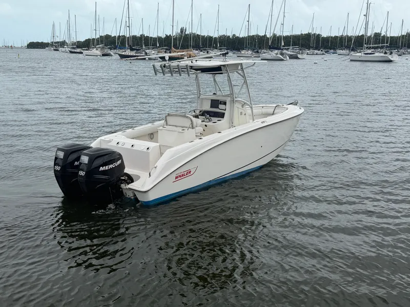 Slide: The Image of 2006 Boston Whaler 240 Outrage boat on water with twin engines. - 2