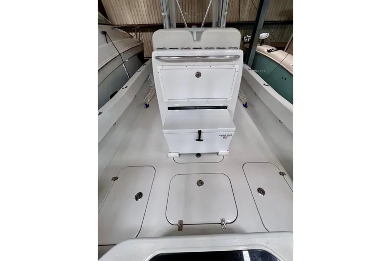 Slide: The Image of 2023 Conch 30 boat interior with storage compartments and seating area. - 16
