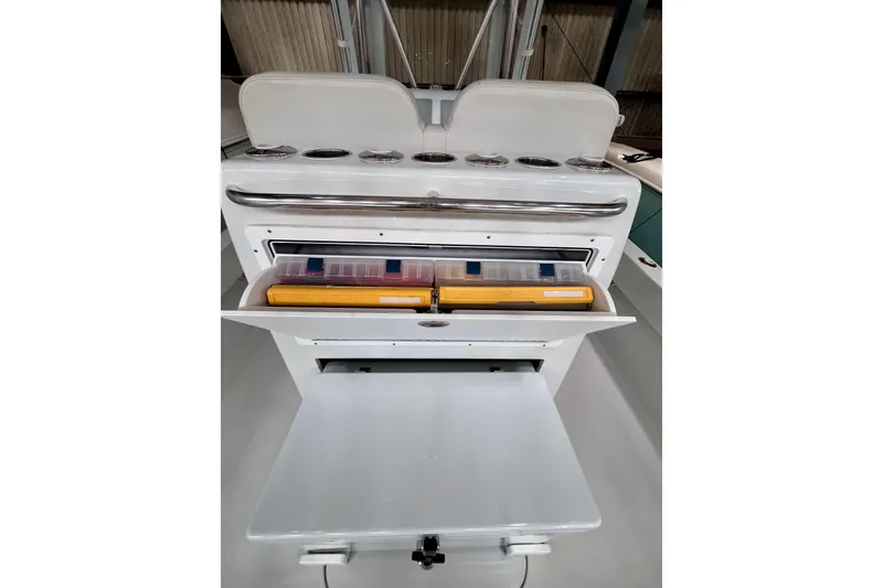 Slide: The Image of 2023 Conch 30 boat storage compartment with tackle boxes and rod holders. - 17