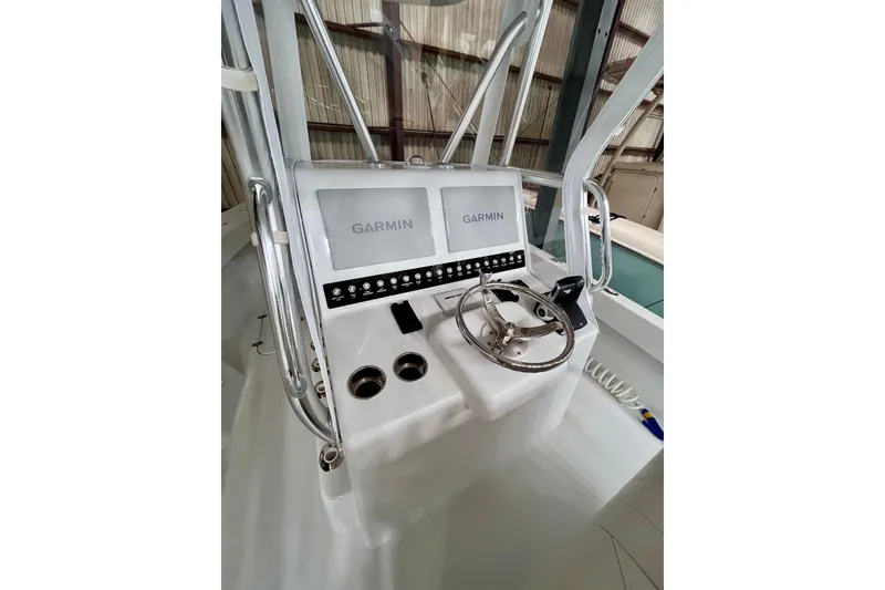 Slide: The Image of 2023 Conch 30 boat console with dual Garmin displays and steering wheel. - 2