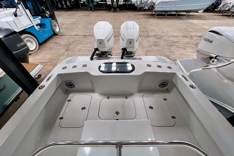 Slide: The Image of 2023 Conch 30 boat with dual Mercury engines in a showroom setting. - 20
