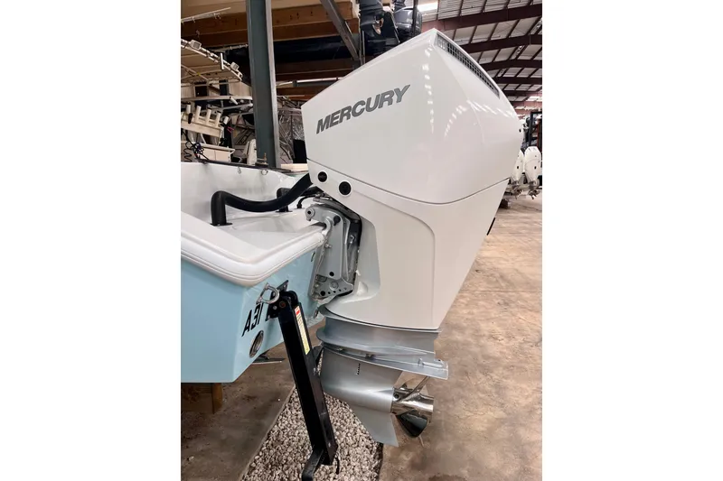 Slide: The Image of 2023 Conch 30 boat with Mercury outboard motor in a showroom setting. - 22