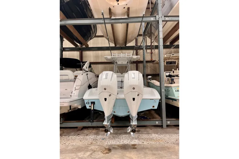 Slide: The Image of 2023 Conch 30 boat with dual outboard engines in storage facility. - 23