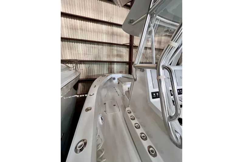 Slide: The Image of 2023 Conch 30 boat interior with sleek design and modern controls in storage facility. - 4