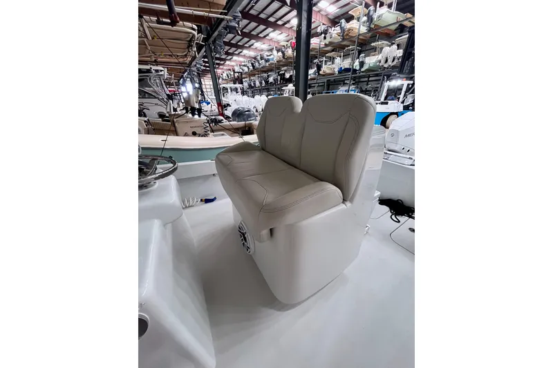 Slide: The Image of 2023 Conch 30 boat interior with beige seating in a showroom. - 6