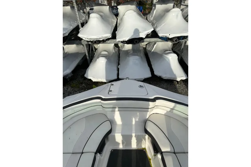 Slide: The Image of 2016 Yamaha Boats 212SS interior with covered boats in storage background. - 16
