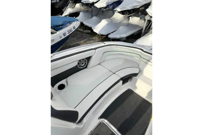 Slide: The Image of Interior view of a 2016 Yamaha Boats 212SS, featuring white seating and a speaker. - 19