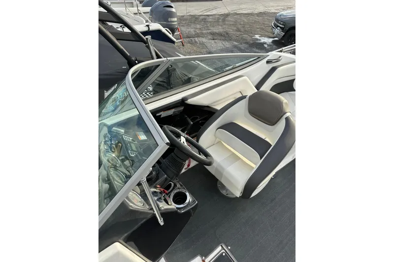 Slide: The Image of 2016 Yamaha Boats 212SS interior with steering wheel and seating. - 20
