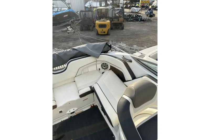 Slide: The Image of 2016 Yamaha Boats 212SS interior with white seating and outdoor storage view. - 22