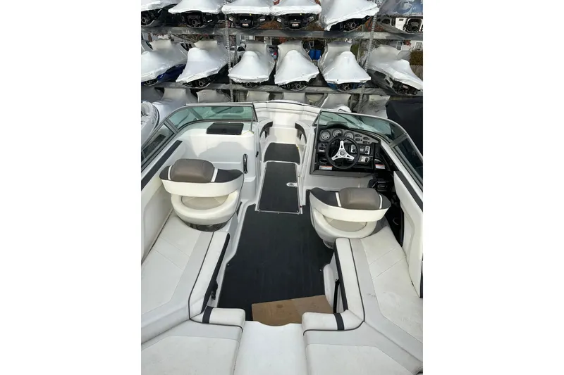 Slide: The Image of 2016 Yamaha Boats 212SS interior with dual captain's chairs and sleek dashboard design. - 26