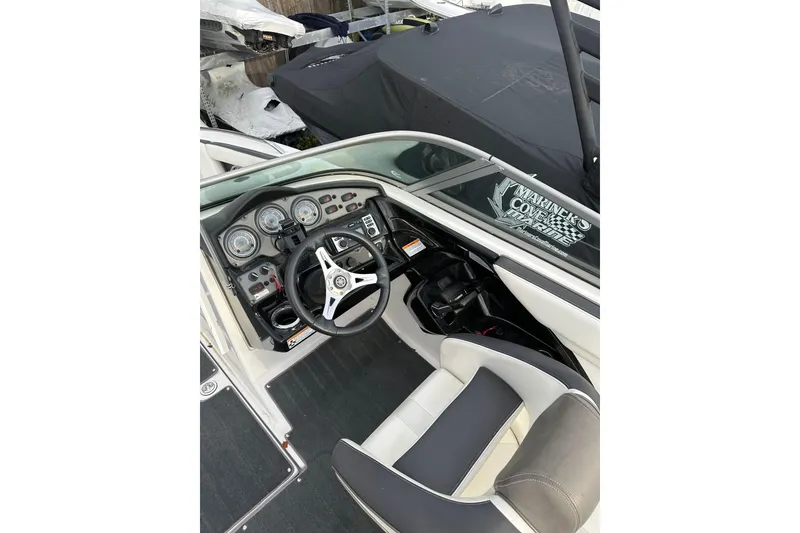 Slide: The Image of 2016 Yamaha Boats 212SS cockpit with steering wheel and dashboard controls. - 28