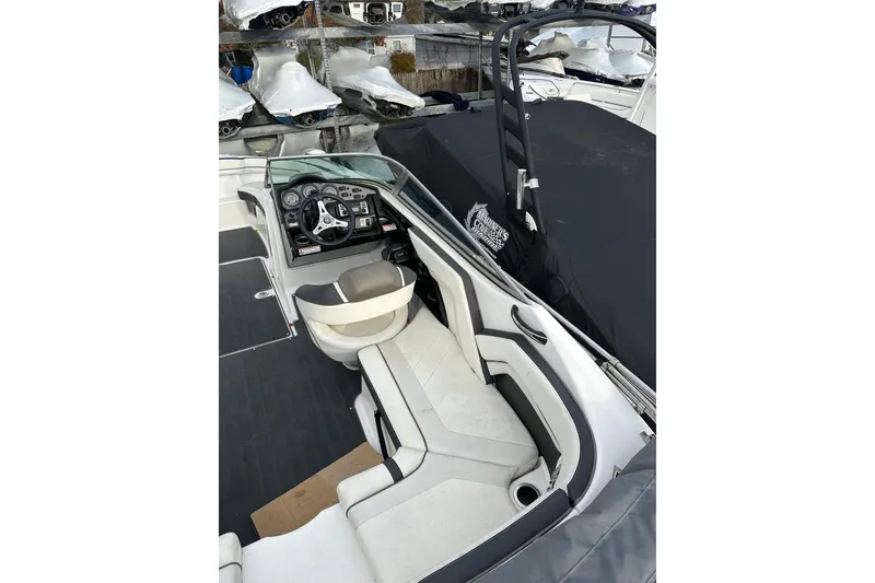 Slide: The Image of 2016 Yamaha Boats 212SS interior with steering wheel and seating, showcasing sleek design. - 29