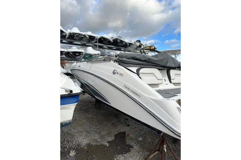 Slide: The Image of 2016 Yamaha Boats 212SS twin-engine boat on display, parked on gravel under a cloudy sky. - 5