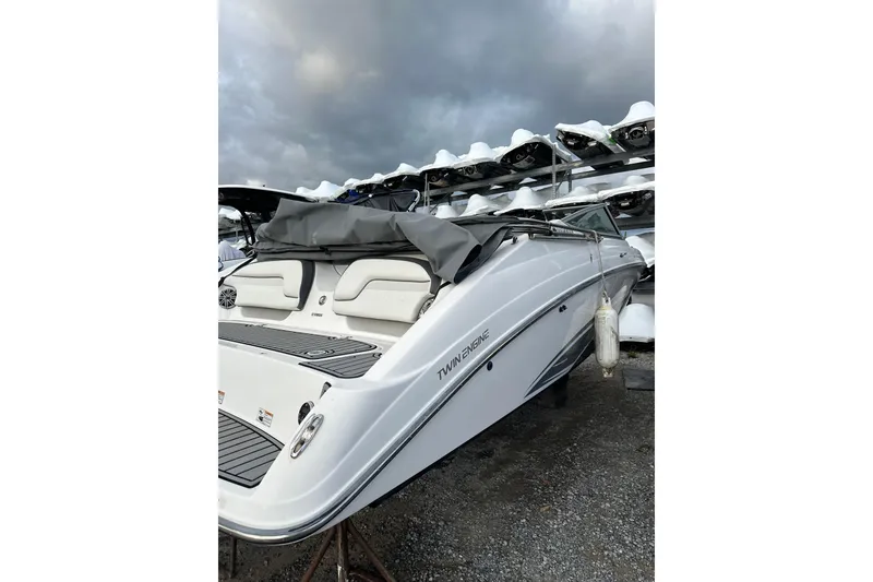 Slide: The Image of 2016 Yamaha Boats 212SS with twin engines, docked under cloudy skies. - 6
