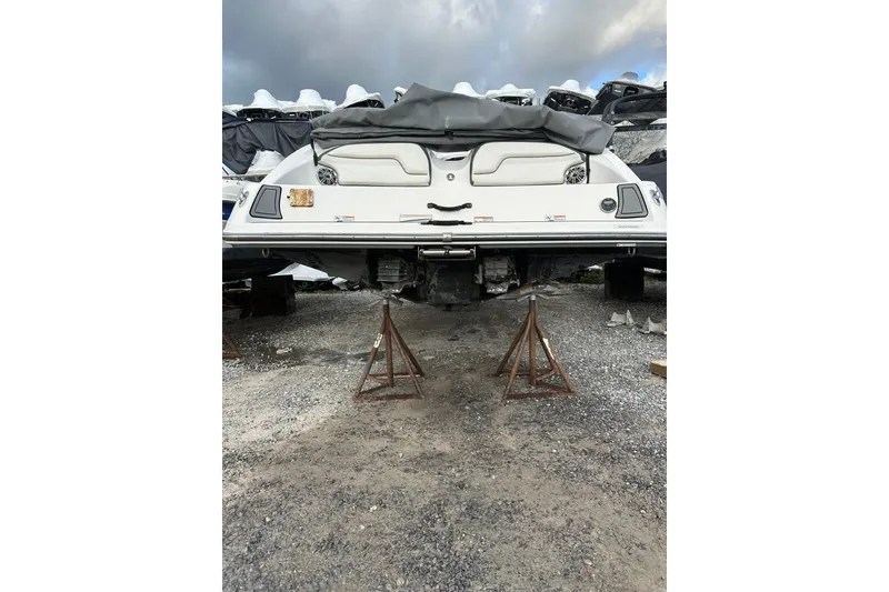 Slide: The Image of 2016 Yamaha Boats 212SS on stands, rear view, with covered seating area. - 9