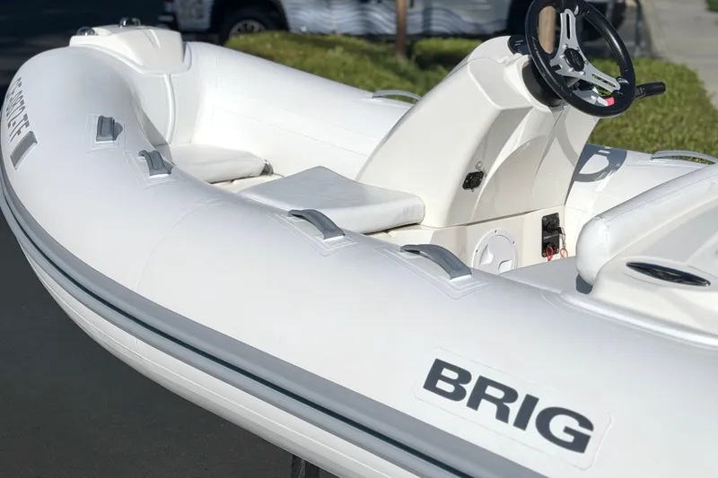 The Image of 2019 Brig Eagle 340 inflatable boat with steering console, white exterior, and sleek design. - 0