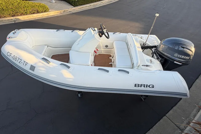 Slide: The Image of 2019 Brig Eagle 340 inflatable boat with Yamaha outboard motor on pavement. - 11