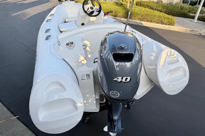 Slide: The Image of 2019 Brig Eagle 340 inflatable boat with Yamaha 40 outboard motor, parked on pavement. - 12
