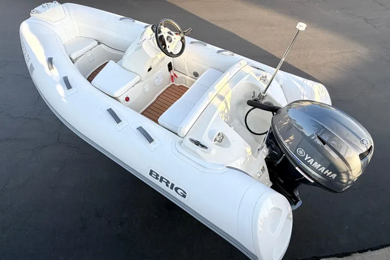 Slide: The Image of 2019 Brig Eagle 340 inflatable boat with Yamaha outboard motor, white interior, and sleek design. - 13