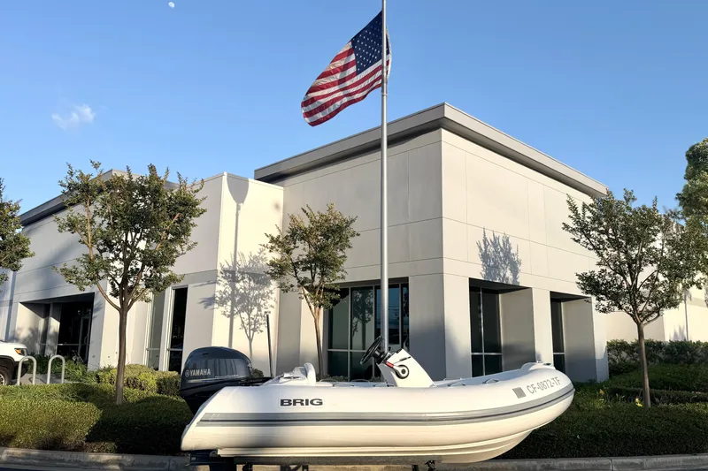 Slide: The Image of 2019 Brig Eagle 340 boat displayed outside modern building with American flag. - 17