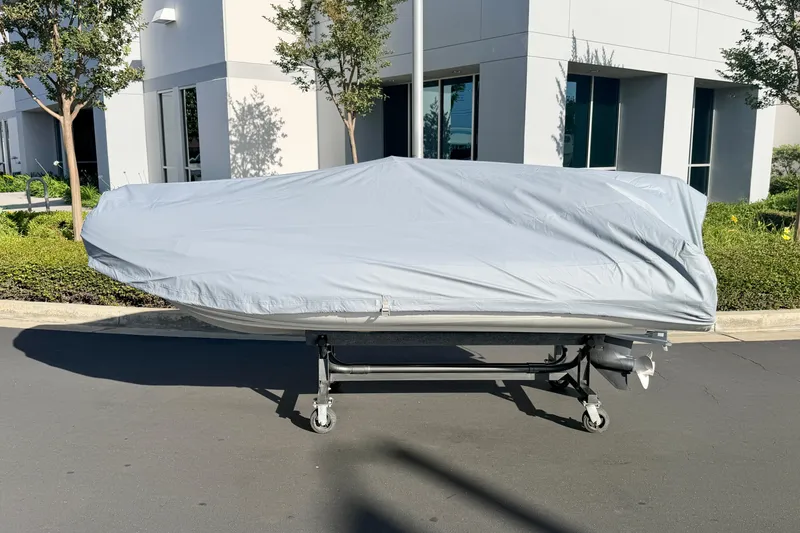 Slide: The Image of 2019 Brig Eagle 340 boat covered, parked outside modern building. - 20